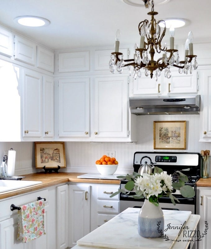 Traditional White Kitchen with Beadboard Backsplash and Crystal Chandelier