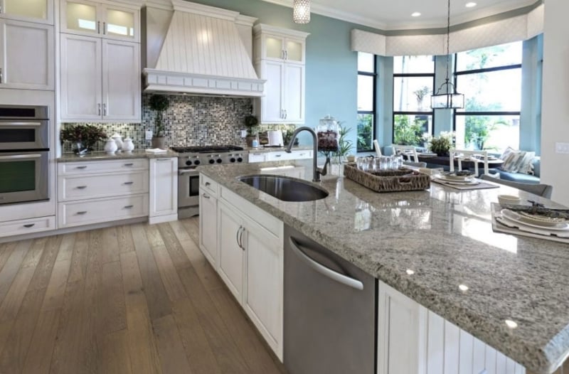 Wide Plank Flooring in Transitional Kitchen with Soft Blue Accent Walls