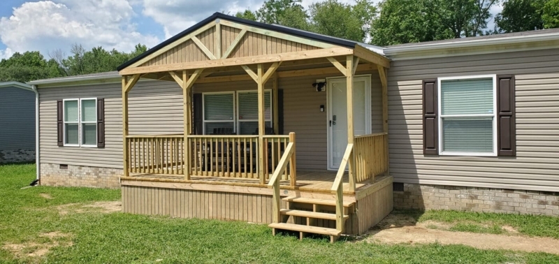A-frame Front Porch with Vertical Underpinning and Wood Railing