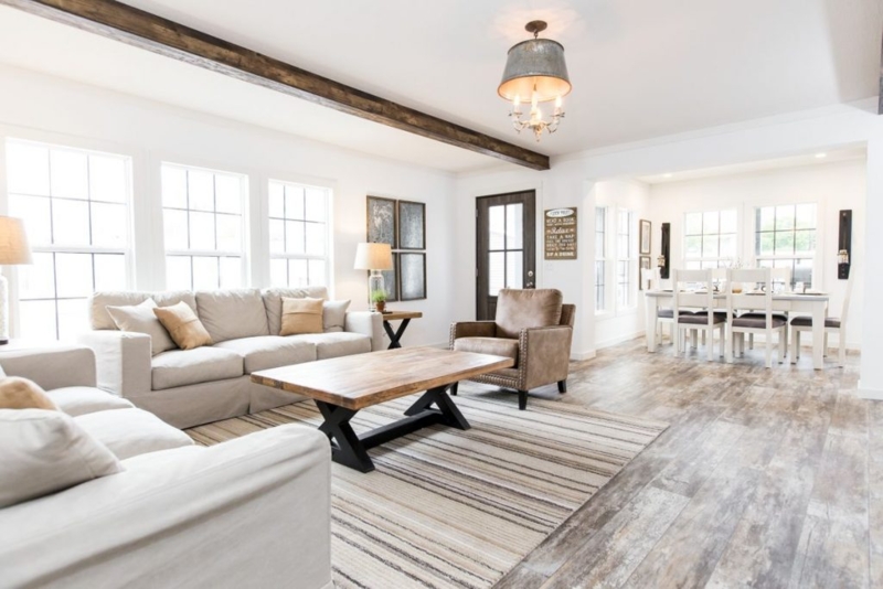Airy Farmhouse Living with Dark Beam, Grid Windows, and Galvanized Light