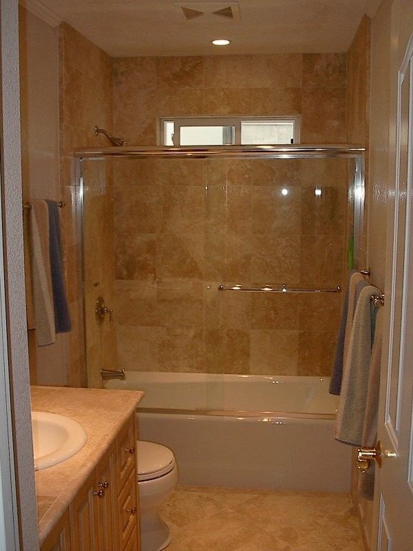 Alcove Bathtub with Sliding Glass Enclosure and Stone Look Tiles