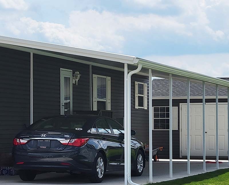 Attached Metal Home Carport with Integrated Gutters and Sloped Roof