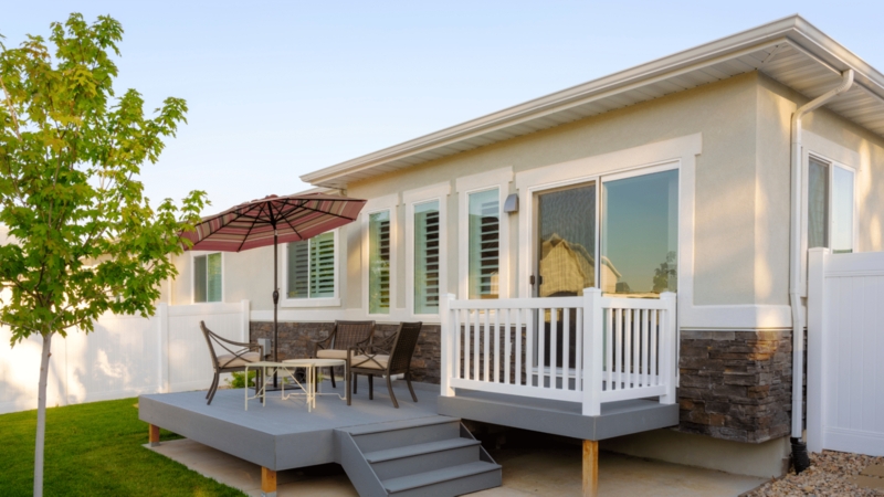 Backyard Deck Grey Raised Platform Stone Veneer Accents Sliding Door