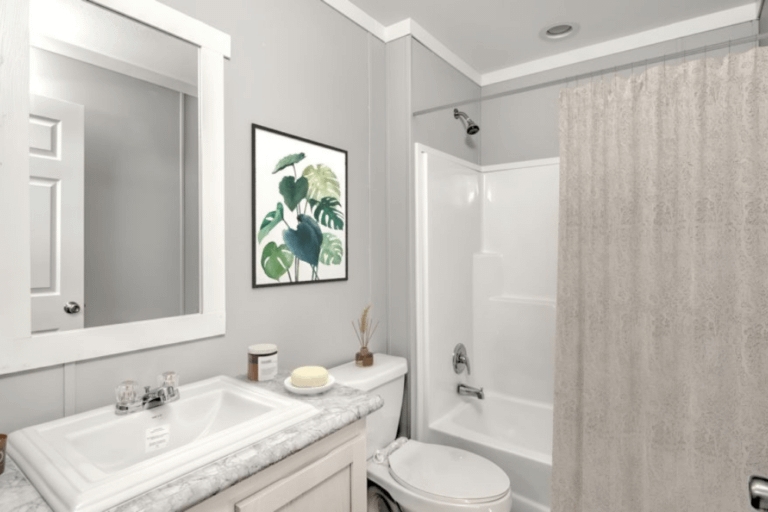 Bathroom Interior featuring Botanical Wall Art and Marbled Countertop