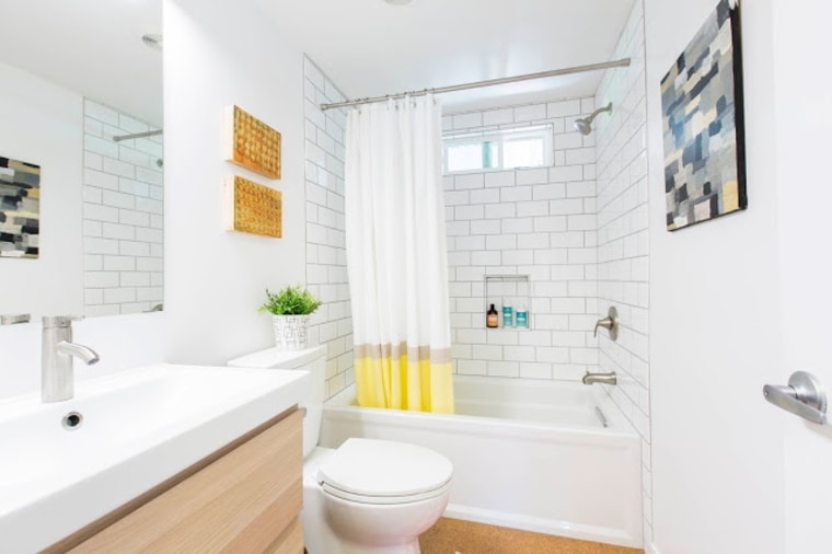 Bathroom Vanity with White Subway Tile and Yellow Dipped Curtain