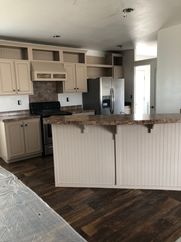 Beige Cabinetry with Beadboard Island Back & Open Cubby Upper Shelving