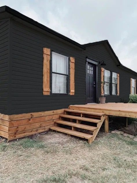 Black Manufactured Home Siding with Wooden Foundation Wrap and Deck