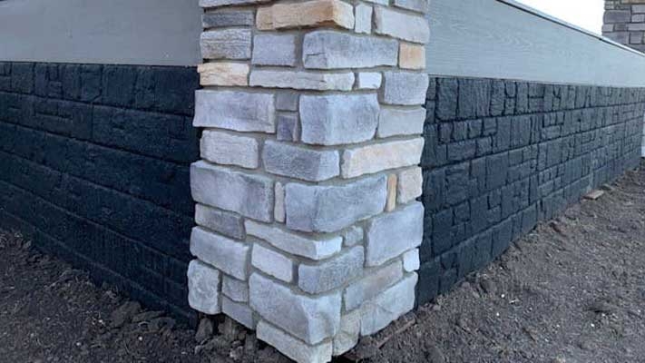 Black Textured Siding Panels with Faux Stone Corner Post.