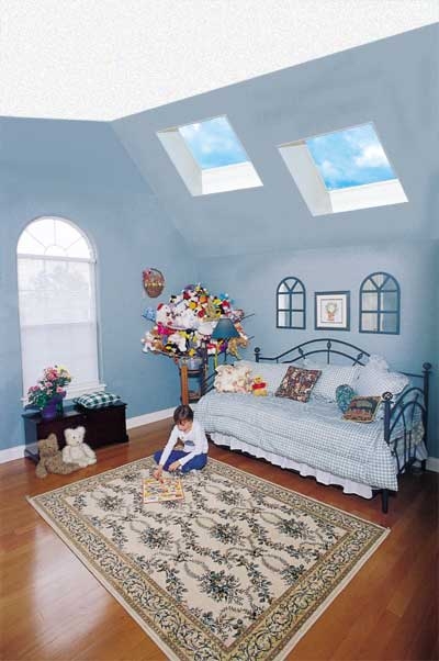 Blue Attic Bedroom Design with Dual Skylights and Vaulted Ceiling