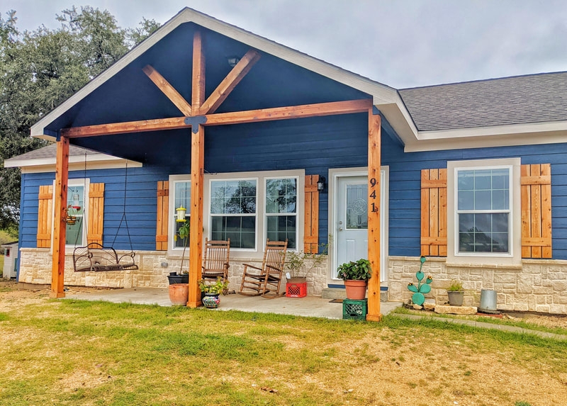 Blue Farmhouse Exterior with Timber Truss Porch