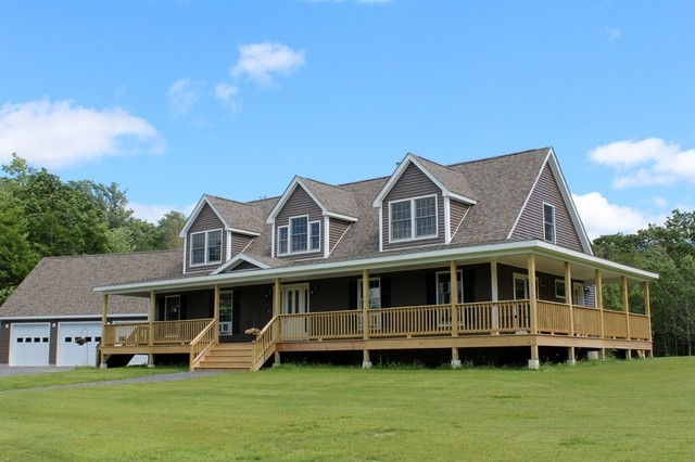 Brown Modular Home with Wrap Around Porch and Triple Dormer Roofline