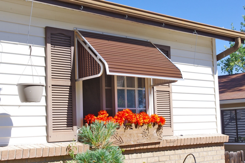 Brown Slatted Window Awning with Coordinated Shutters