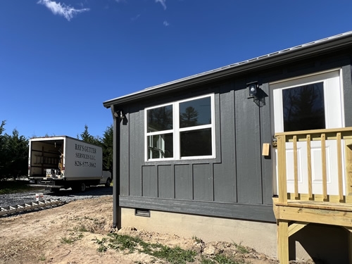 Cabin Exterior Board and Batten Siding in Dark Gray with White Trim
