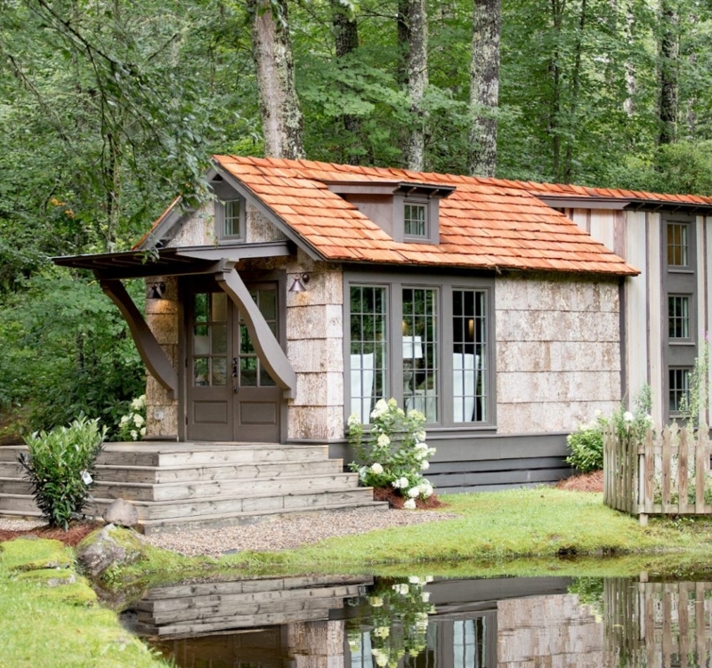 Cabin with Unique Bark Textured Siding and Orange Roof