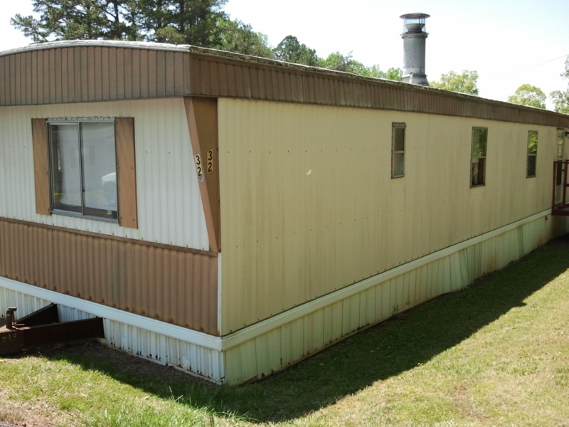 Classic Single-Wide Mobile Home with Two-Tone Exterior and Ribbed Siding