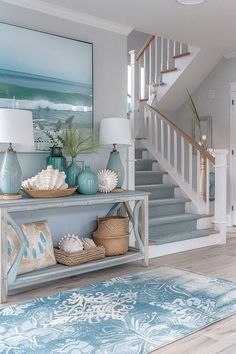 Coastal Console Table Styling: Blue Lamps, Ocean Art, & Woven Decor
