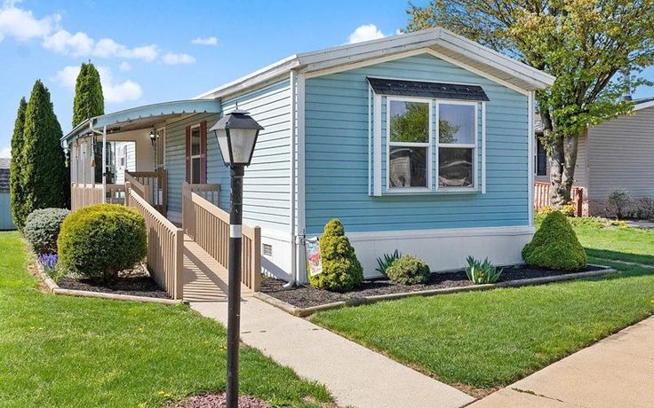 Coastal Exterior with Accessible Wooden Ramp and Light Blue Siding