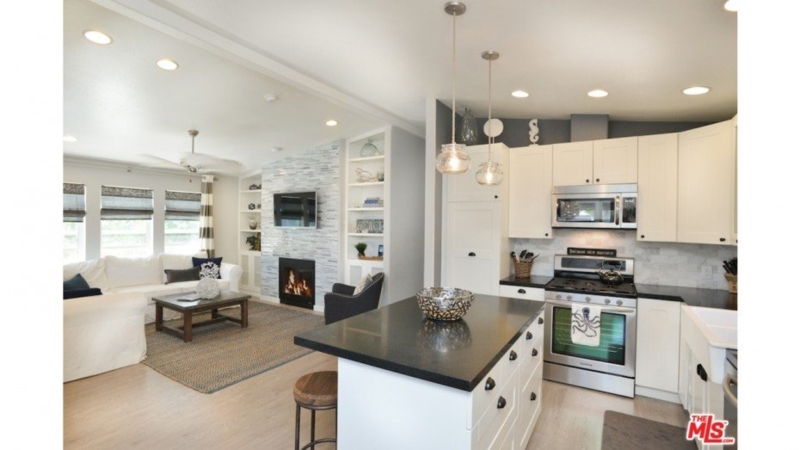 Coastal Living Room with Tiled Fireplace and White Built-In Shelving