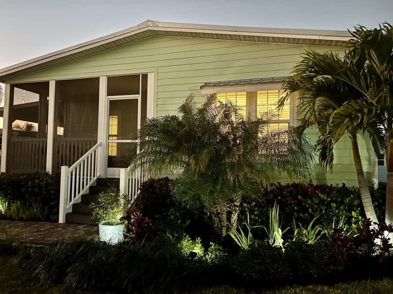 Coastal Mobile Home Exterior: Sage Green Siding with Screened Porch
