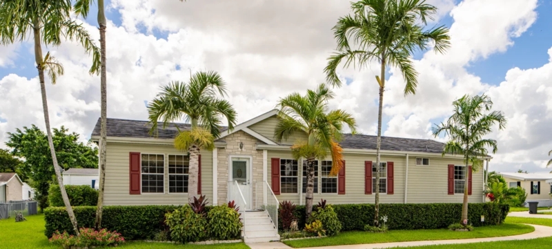 Coastal Mobile Home Exterior with Green Siding and Red Shutters