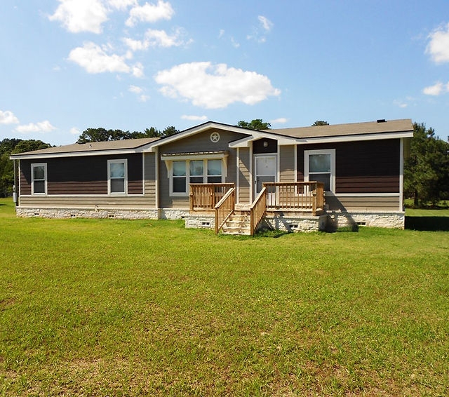 Contemporary Manufactured Home Two-Tone Siding Stone Skirting Deck
