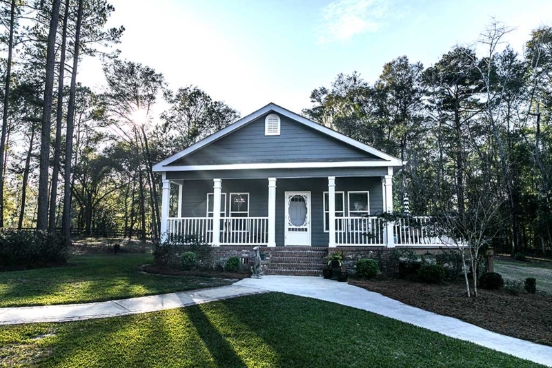 Cottage Style Manufactured Home: Blue-Gray Siding with Brick Skirting