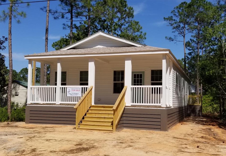 Cottage Style Porch with Unpainted Wooden Steps and Skirting