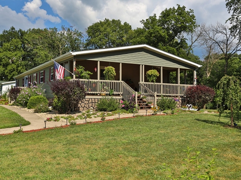 Covered Mobile Home Porch with Gabled Roof and Stone Look Skirting