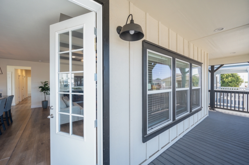 Covered Porch: Cream Board and Batten Siding with Dark Window Trim