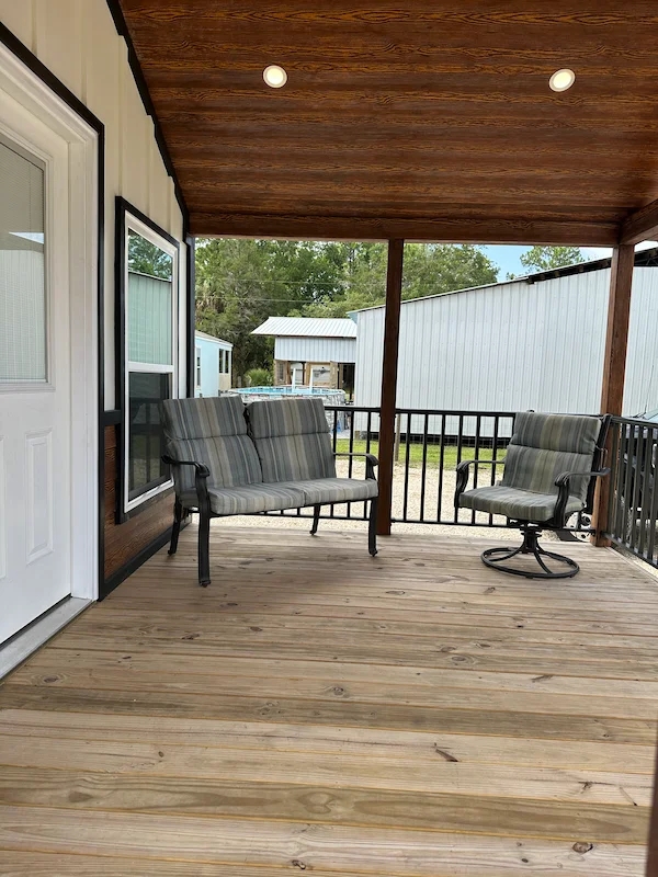 Covered Porch with Paneled Ceiling and Striped Patio Seating