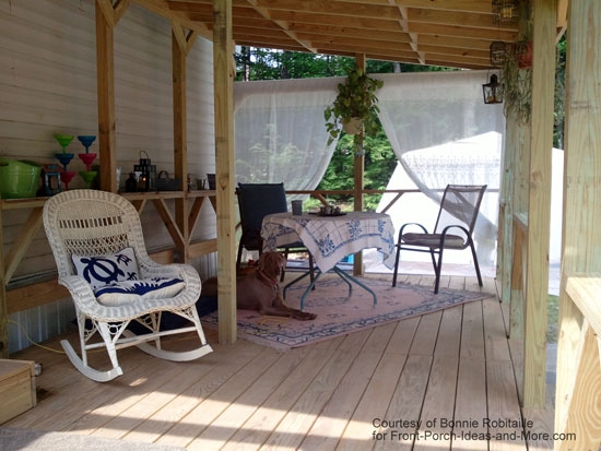 Covered Porch with White Wicker Rocker & Sheer Curtains