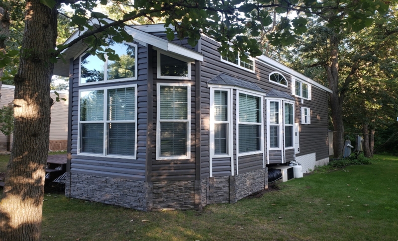 Dark Charcoal Mobile Home Exterior with Stone-Look Skirting