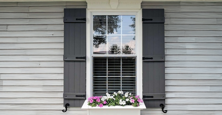 Dark Gray Board and Batten Exterior Shutters with Black Hardware