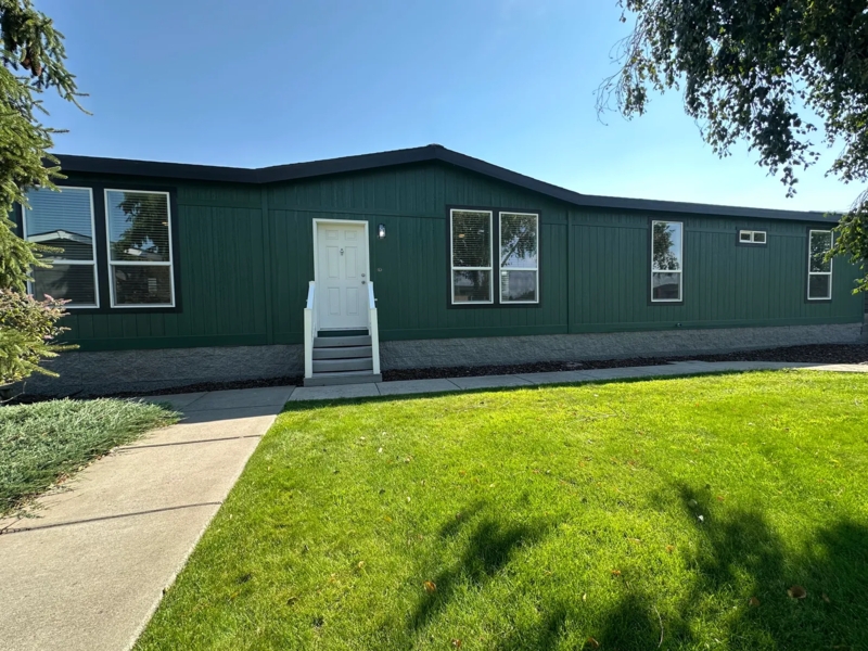 Dark Green Manufactured Home Exterior with White Contrasting Trim