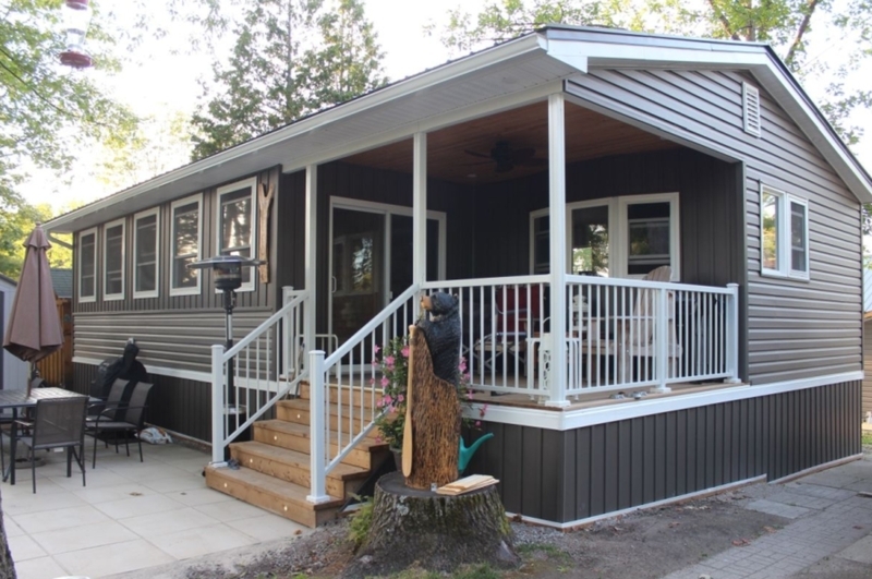 Dark Mobile Home Porch: Integrated Stair Lighting & Bear Sculpture