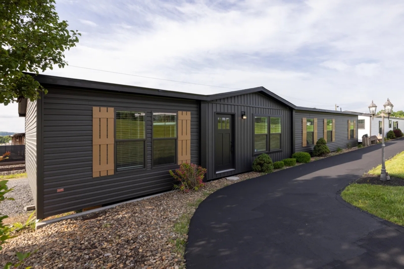 Dark Siding Manufactured Home: Wood-Toned Board and Batten Shutters