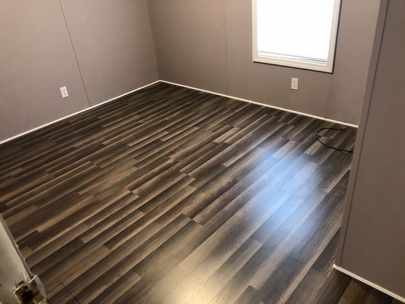 Dark Wood Look Vinyl Flooring: Staggered Plank in Empty Room