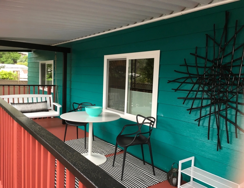 Deck Outdoor Space Vibrant Teal Siding Red Railing Geometric Wall Art