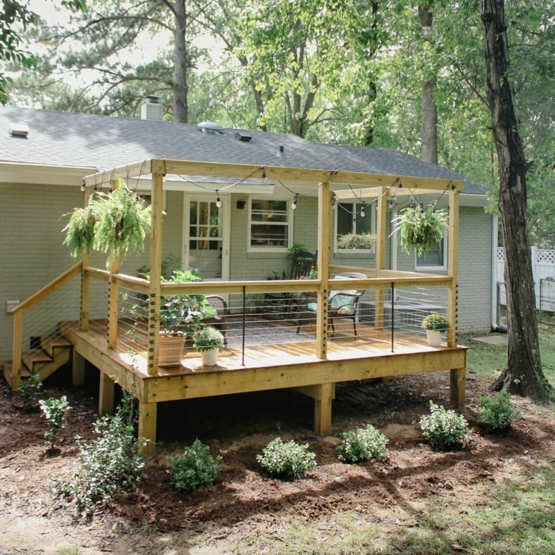 Deck with Integrated Pergola Frame, Cable Railing, and String Lights