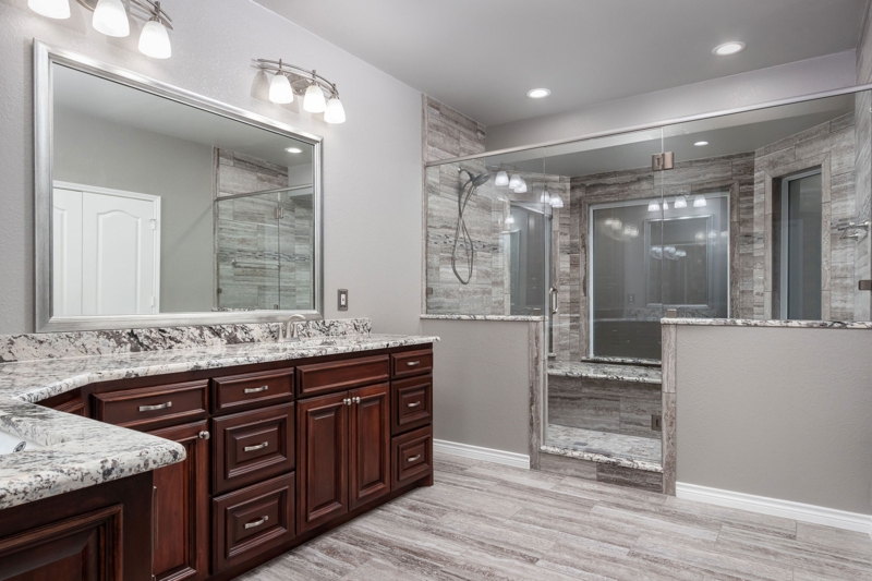Double Bathroom Vanity with Dark Wood and Granite Countertop