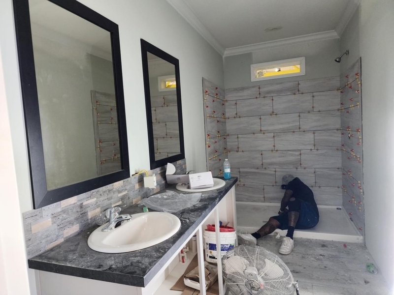 Double Vanity with Black Framed Mirrors and Grey Wood Look Tile