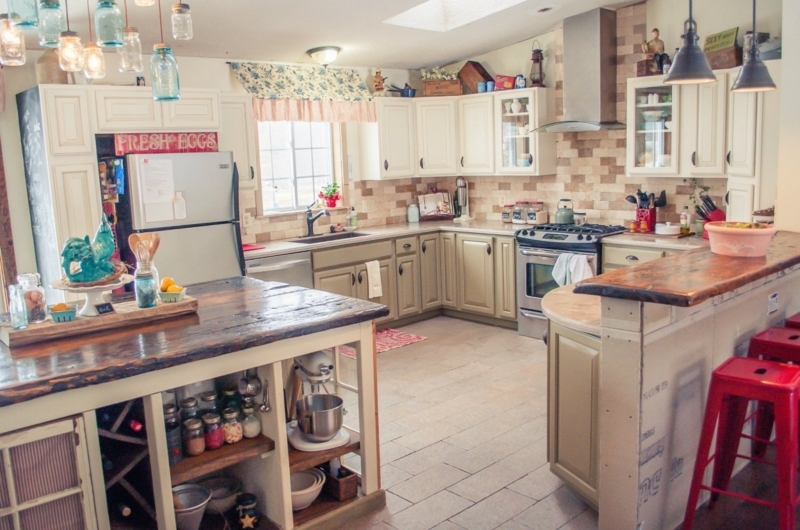 Eclectic Farmhouse Kitchen with Rustic Wood Island and Red Stools