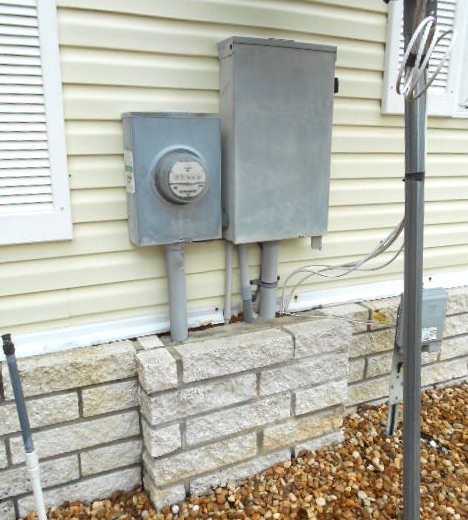 Electric Meter Box near Stone Foundation, Exterior Utility Placement