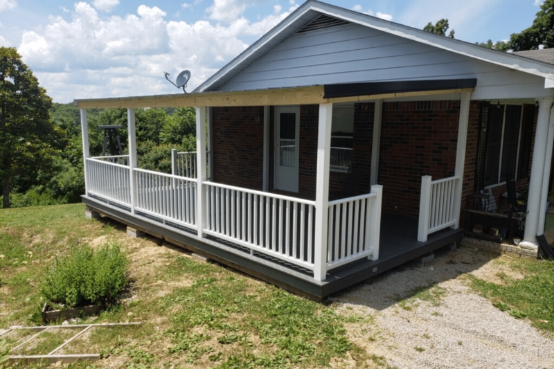 Elevated Porch with White Vinyl Railing and Dark Composite Decking