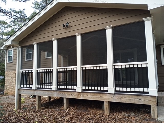 Elevated Screened Porch Design with White Columns and Black Railings