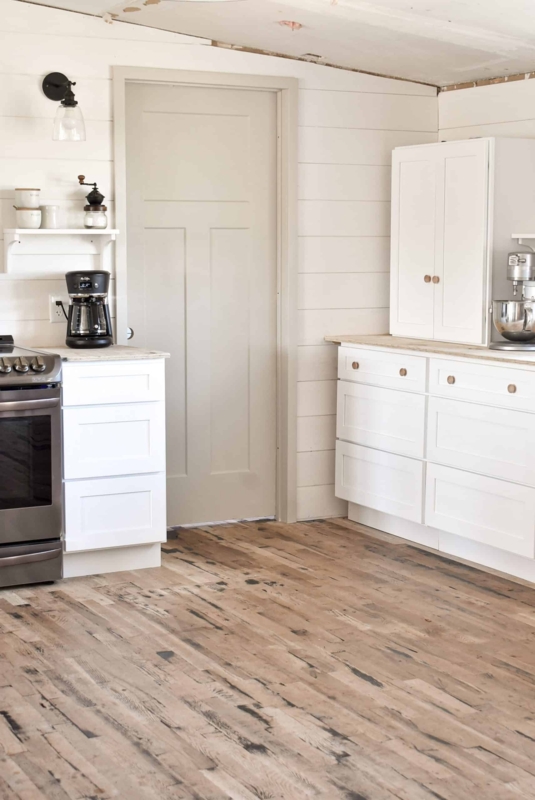 Farmhouse Kitchen with Shiplap Walls and Rustic Plank Flooring