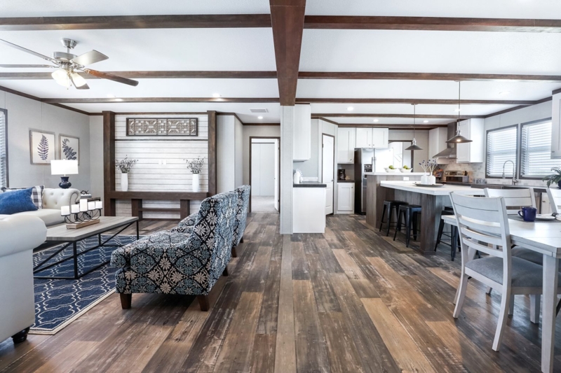 Farmhouse Living Room with Wide Plank Wood Flooring and Beams