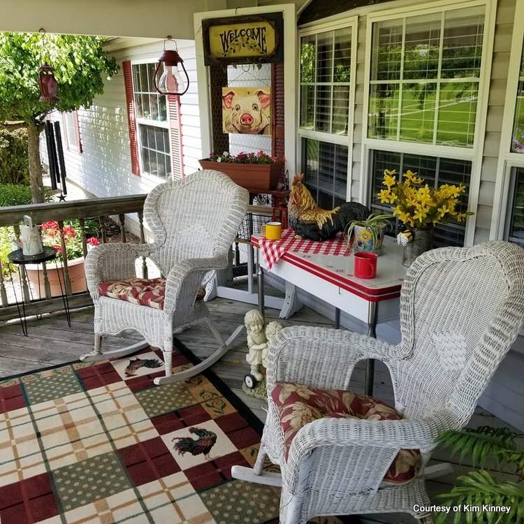 Farmhouse Porch with White Wicker Chairs and Patchwork Rug