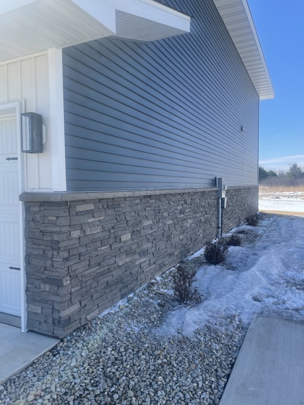 Faux Ledgestone House Skirting with Gravel Border and Blue Siding Contrast