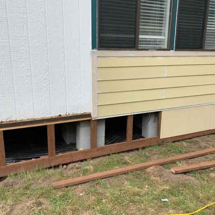 Foundation Skirting Installation showing Exposed Wood Framing